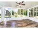 Large sunroom boasts walls of glass that showcase the serene views of the yard at 186 Ellendale Ln, Taylorsville, NC 28681