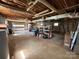 Spacious unfinished basement with exposed wood ceiling, storage shelving and garage door access at 1869 Wooten St, Catawba, NC 28673