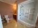 Bathroom featuring a shower-tub combo, toilet, vanity with sink, and updated light fixtures at 1869 Wooten St, Catawba, NC 28673