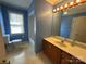 Bathroom with a large vanity, double sinks, window, and a toilet at 1869 Wooten St, Catawba, NC 28673