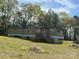 Exterior view of a single-wide home with a small porch and green grass at 1869 Wooten St, Catawba, NC 28673