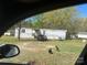Exterior view of a single-wide home with a car parked in front and some chickens in the yard at 1869 Wooten St, Catawba, NC 28673