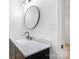 Powder room featuring a black framed mirror, modern vanity, and marble countertops at 1904 27Th Avenue Ne Dr, Hickory, NC 28601