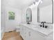 Bathroom featuring a double vanity with marble countertop, modern fixtures, and wood floors at 1904 27Th Avenue Ne Dr, Hickory, NC 28601
