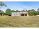 Rear exterior view featuring a white brick home with a spacious deck and two-car garage at 1904 27Th Avenue Ne Dr, Hickory, NC 28601