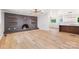 Open-concept living room with decorative brick fireplace, wood floors, and ceiling fan at 1904 27Th Avenue Ne Dr, Hickory, NC 28601