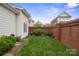 Well-maintained backyard with lush grass, charming brick features, and manicured landscaping at 20217 Middletown Rd, Cornelius, NC 28031