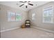 Bright bedroom with neutral carpet, featuring 3 windows for ample natural light at 20217 Middletown Rd, Cornelius, NC 28031