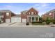 Charming brick home featuring a welcoming front porch, well-maintained landscaping, and a spacious two-car garage at 20217 Middletown Rd, Cornelius, NC 28031