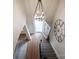 Elegant foyer with hardwood floors, chandelier, staircase, and open doorway at 20217 Middletown Rd, Cornelius, NC 28031