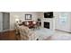 Cozy living room with a fireplace, a leather sofa, and neutral tones at 20217 Middletown Rd, Cornelius, NC 28031