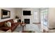 Cozy living room features a fireplace, large windows, and a sliding glass door to the patio at 20217 Middletown Rd, Cornelius, NC 28031