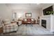 Living room with fireplace, wood floors, neutral tones, and comfortable seating at 20217 Middletown Rd, Cornelius, NC 28031