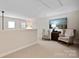 Cozy loft area featuring plush armchairs, neutral carpeting, and bright natural light at 20217 Middletown Rd, Cornelius, NC 28031