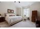Bright main bedroom with a ceiling fan, neutral colors, large bed, decor and a window at 20217 Middletown Rd, Cornelius, NC 28031