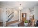 Elegant office and foyer view with hardwood floors, modern chandelier, staircase and neutral color scheme at 20217 Middletown Rd, Cornelius, NC 28031