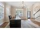 Bright office space featuring hardwood floors, large windows, and a stylish chandelier at 20217 Middletown Rd, Cornelius, NC 28031