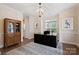 Home office with hardwood flooring, a classic hutch, and natural light from multiple windows at 20217 Middletown Rd, Cornelius, NC 28031