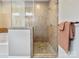 Modern tile and glass walk-in shower with seating and updated shower head fixtures at 20217 Middletown Rd, Cornelius, NC 28031