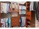 Walk-in closet with built in wooden cabinets and drawers, shelves and hanging racks at 20217 Middletown Rd, Cornelius, NC 28031