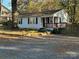 Charming single-story home with white siding, black shutters, inviting deck, and a gravel driveway at 2122 Hope Dr, Rock Hill, SC 29730