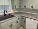 Kitchen featuring light green cabinetry, a deep sink with a black faucet, and modern appliances at 2122 Hope Dr, Rock Hill, SC 29730