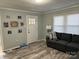 Inviting living room with gray sofa, wood-look floors, neutral paint and natural light from the window at 2122 Hope Dr, Rock Hill, SC 29730