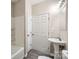 Bright bathroom featuring a white pedestal sink, modern fixtures, and a tiled shower and tub combination at 2515 Carya Pond Ln, Charlotte, NC 28212