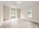 A sunlit bedroom features new flooring, crown molding, and two large windows offering ample natural light at 2515 Carya Pond Ln, Charlotte, NC 28212