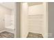 Walk-in closet with new tub-shower combo and wire shelving. Perfect for organizing belongings at 2515 Carya Pond Ln, Charlotte, NC 28212