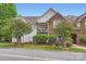 Brick and siding condo with well-kept landscaping, mature trees, and a small balcony add character at 2515 Carya Pond Ln, Charlotte, NC 28212