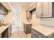 Galley kitchen featuring neutral countertops, modern appliances, and ample cabinet space at 2515 Carya Pond Ln, Charlotte, NC 28212