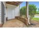 Outdoor patio area with brick base, white siding, and greenery, with a sliding door leading to the unit at 2515 Carya Pond Ln, Charlotte, NC 28212