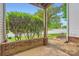 Outdoor patio area with a brick retaining wall and view of the street and surrounding greenery at 2515 Carya Pond Ln, Charlotte, NC 28212