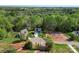 Expansive aerial view of a gray home, foundation, mature trees, and circular driveway at 2668 Polo Ln, Maiden, NC 28650