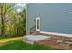 Back patio with brick stairs, black metal railings, and landscaping against the home's exterior at 2668 Polo Ln, Maiden, NC 28650