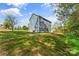 The backyard has a gentle slope, complemented by a well-maintained lawn and diverse landscaping at 2668 Polo Ln, Maiden, NC 28650
