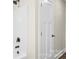 Corner of bathroom featuring a white shower with sleek black fixtures and a white paneled door at 2668 Polo Ln, Maiden, NC 28650