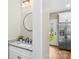 Modern powder room featuring granite countertops, a round mirror, and a view into the bright kitchen at 2668 Polo Ln, Maiden, NC 28650