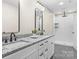 Bathroom featuring dual vanities, sleek black fixtures, and a glass enclosed shower at 2668 Polo Ln, Maiden, NC 28650