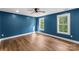 Spacious bedroom with hardwood floors, bright windows, and a contemporary ceiling fan at 2668 Polo Ln, Maiden, NC 28650