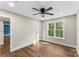 Bright bedroom features wood floors, ceiling fan, and a large window providing natural light at 2668 Polo Ln, Maiden, NC 28650