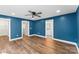 Hardwood floored bedroom with ensuite bathroom featuring black fixtures, and a contemporary ceiling fan at 2668 Polo Ln, Maiden, NC 28650