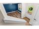 From the upper staircase landing, view of bonus room with blue walls, wood flooring, and a bright entry doorway at 2668 Polo Ln, Maiden, NC 28650