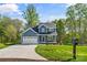Charming two-story home with blue siding, an attached two-car garage and a well-manicured lawn at 2668 Polo Ln, Maiden, NC 28650
