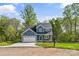 Charming two-story home with blue siding, an attached two-car garage and a well-manicured lawn at 2668 Polo Ln, Maiden, NC 28650