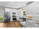 Renovated kitchen with stainless steel appliances, granite countertops, white cabinets, and lots of natural light at 2668 Polo Ln, Maiden, NC 28650