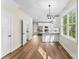 Sunlit dining area with modern light fixtures and stainless appliances leads to a view of the bathroom and kitchen at 2668 Polo Ln, Maiden, NC 28650