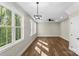 Spacious, bright living room with large windows, modern lighting, and wood floors offers a comfortable space at 2668 Polo Ln, Maiden, NC 28650