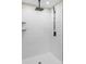 Close-up of modern tiled shower featuring black fixtures and built in shelves at 2668 Polo Ln, Maiden, NC 28650